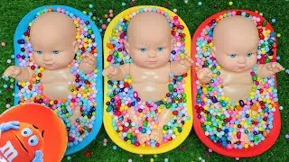 Thumbnail: Three Baby Dolls Playing with Colorful Beads and Bowls
