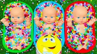 Thumbnail: Three Baby Dolls Playing with Colorful Beads and Bowls