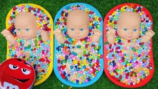 Thumbnail: Three Baby Dolls Playing with Colorful Beads and Bowls
