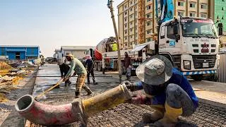 Thumbnail: Perfectly village concrete road construction with skilled worker use Paving machine technology.