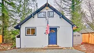 Thumbnail: Cozy Small Cottage in the Woods with a Charming Blue Door