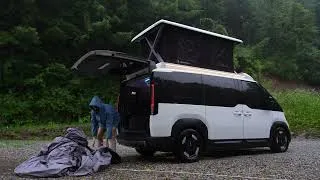 Thumbnail: Camping in heavy rain inside the KIA PV5 camper van with a pop-up roof.