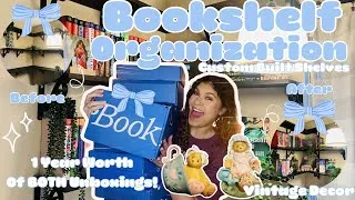 Thumbnail: NEW BOOKSHELF ORGANIZATION 💙 | HUGE BOOK HAUL | 1 YEAR OF BOOK OF THE MONTH UNBOXINGS 