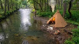Thumbnail: Camping trip with a tent and stove Cooking on a wood-burning stove in the wild