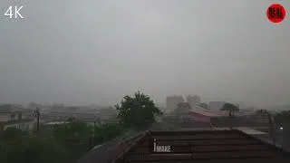 Thumbnail: Heavy rain storm over city residential area. Torrential rainfall, dark overcast sky, windy weather.