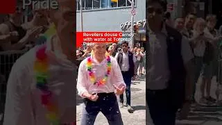 Thumbnail: Revellers douse Carney with water at Toronto Pride