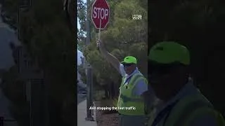 Thumbnail: Crossing guard places himself in front of car to protect students