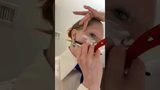Thumbnail: Woman shaving her face with a straight-edge razor