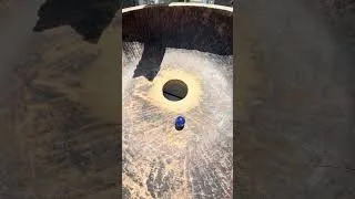 Thumbnail: Marbles spinning round and round in a wooden kneading bowl